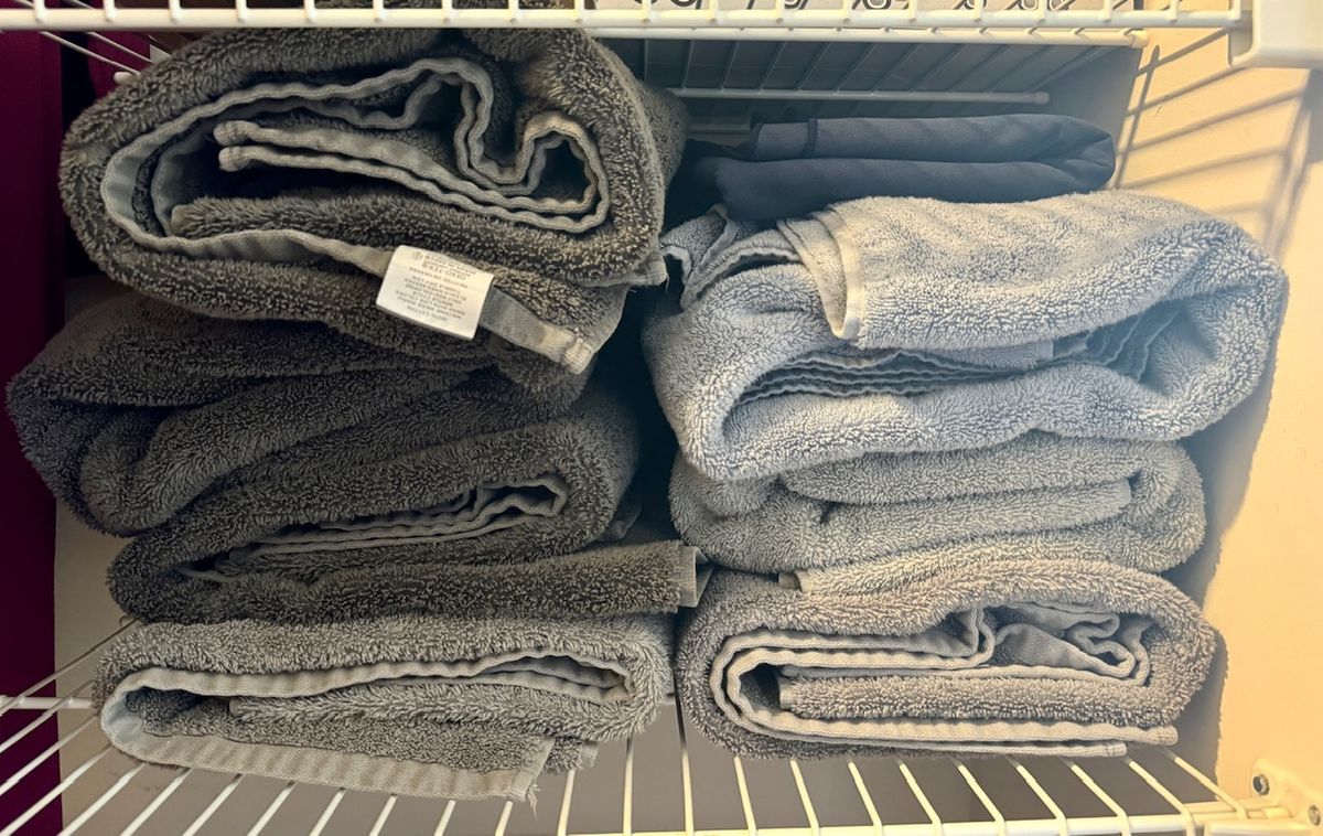 Eight towels on a closet shelf