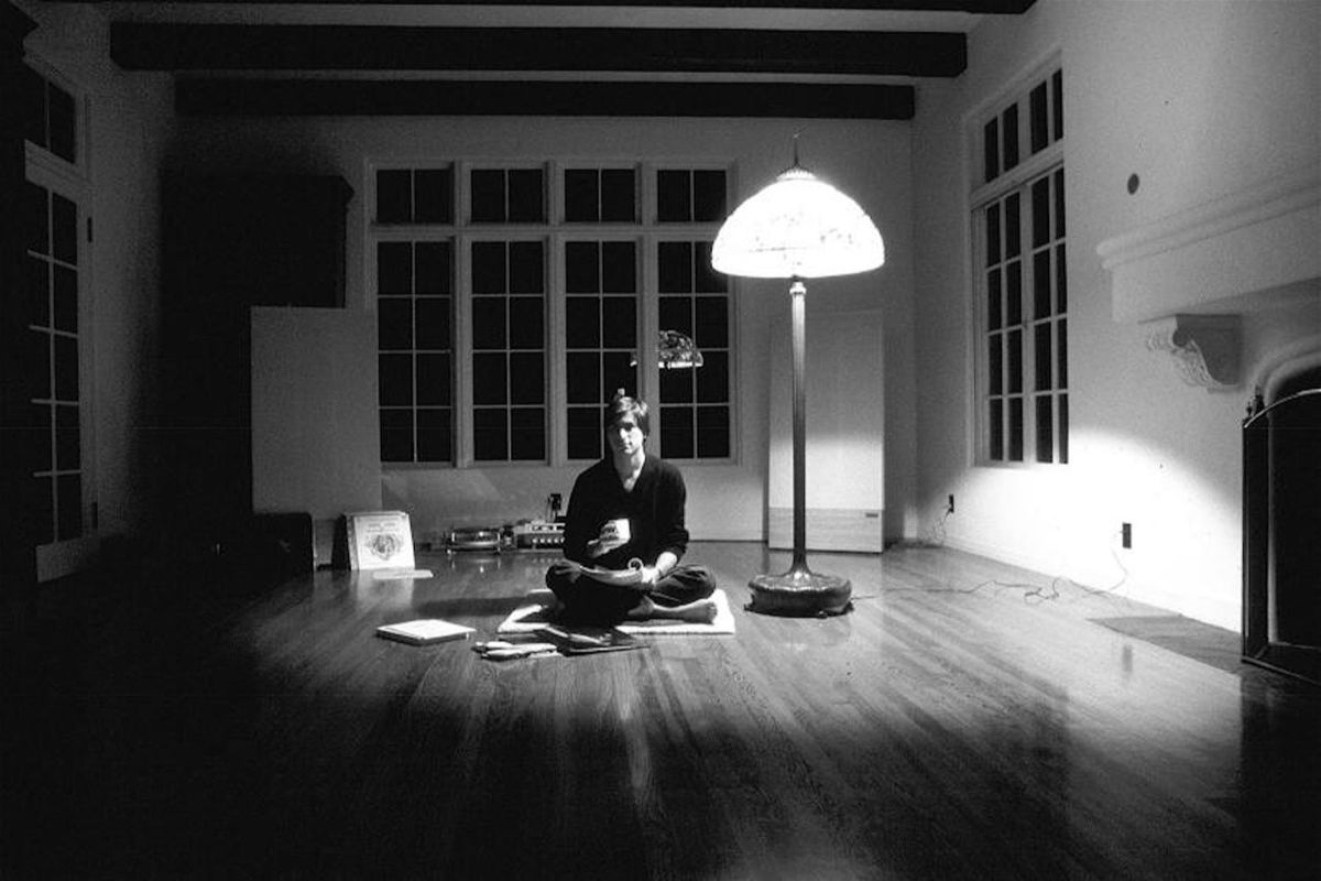 Steve Jobs sitting on the floor of his home